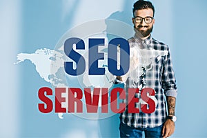 professional successful developer pointing at world map