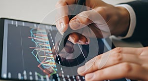 Businessperson Analyzing Financial Data on Digital Tablet