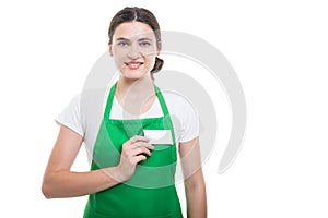 Professional supermarket seller holding business card