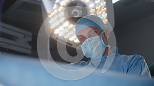 Professional surgeon uses laparoscopic instruments