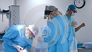 Professional surgeons prepare for heart surgery in a state-of-the-art surgery room