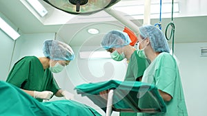 Professional surgeons team performing surgery in the operating room, surgeon, Assistants, and Nurses Performing Surgery on a