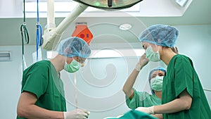 Professional surgeons team performing surgery in the operating room, surgeon, Assistants, and Nurses Performing Surgery on a