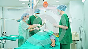 Professional surgeons team performing surgery in the operating room, surgeon, Assistants, and Nurses Performing Surgery on a