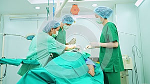 Professional surgeons team performing surgery in the operating room, surgeon, Assistants, and Nurses Performing Surgery on a