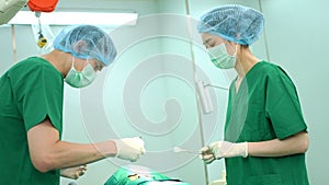 Professional surgeons team performing surgery in the operating room, surgeon, Assistants, and Nurses Performing Surgery on a