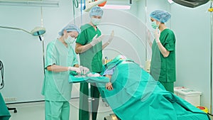 Professional surgeons team performing surgery in the operating room, surgeon, Assistants, and Nurses Performing Surgery on a