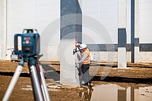 Professional surveyor using gps system and theodolite for correct level on construction site