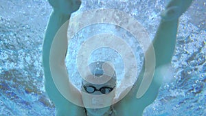 Professional swimmer performing butterfly stroke, training in pool