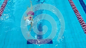 Professional swimmer practicing in water swimming pool. Top view
