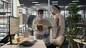 Professional team analyzing archived data on a modern device