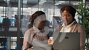 Professional team analyzing archived data on a modern device