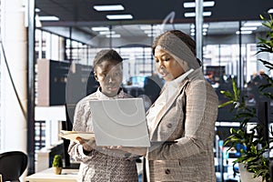 Professional team analyzing archived data on a modern device