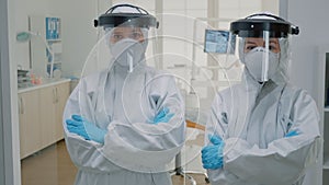 Professional team of dentists in ppe suits standing