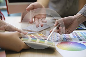 Professional team of interior designers brainstorming and discussing ideas together at creative office