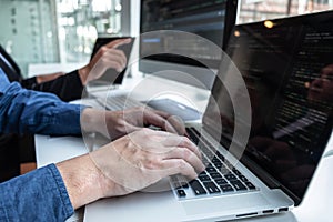 Professional Team of programmer working on project in software development computer in IT company office, Writing codes and data