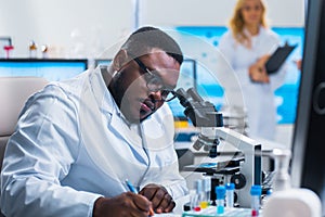 Professional team of scientists is working on a vaccine in a modern scientific research laboratory. Genetic engineer photo