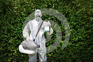 Professional technical man in prevention suit with his sterilizing machine and disinfecting water in his hand. He is ready to take