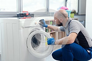 Professional technician checking a washing machine