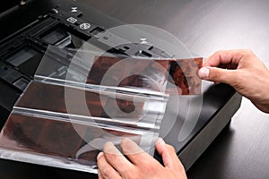 Professional technician hand scanning negative film and slides,