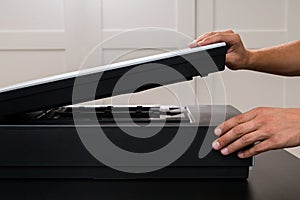 Professional technician hand scanning negative film and slides,
