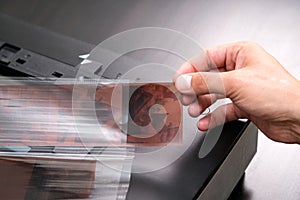 Professional technician hand scanning negative film and slides,
