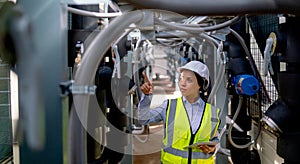 Professional technician worker or engineer woman stay in area of pipe network and point to the left side in area of construction