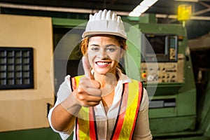 Professional technicians and engineers wearing protective clothing showing thumbs up. Technician in the industry at machine