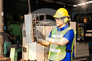 Professional technicians are operating the machine with a remote control in an industrial factory