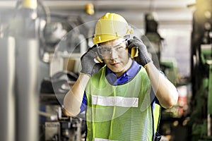 Professional technicians wear protective equipment and hard hats in large industrial plants. Protective and Safety Equipment eye