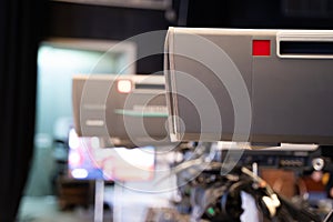 Professional television camera with large lens on a tripod during TV recording