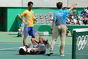 Professional tennis player Dustin Brown of Germany needs medical attention during first round match of the Rio 2016 Olympic Games