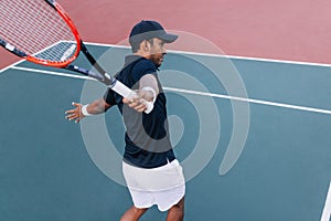 Professional tennis player practicing one-handed backhand hit