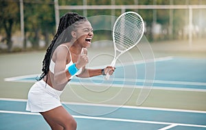 Professional tennis player screaming in excitement after a match. African american woman cheering her success after a