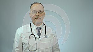 Professional therapist putting stethoscope around neck, ready to examine patient