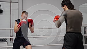 Professional training of two kickboxers on ringside in fight club.