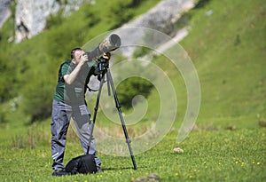 Professional travel on location and nature videographer/photographer man photographing wildlife