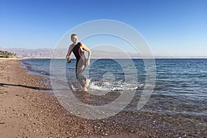 Professional triathlete practicing in open water. Swimming in se