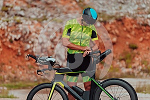 A professional triathlete preparing for a training ride on a bicycle