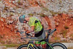 A professional triathlete preparing for a training ride on a bicycle