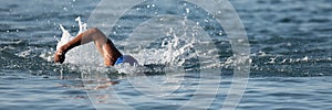 Professional triathlete swimming in ocean open water