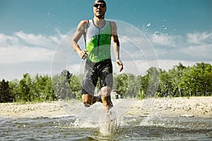 Professional triathlete swimming in river`s open water