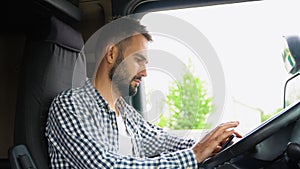 Professional trucker using truck gps navigation to transport and deliver goods to the destination. Transportation