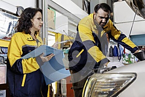 Professional Uniformed Car Mechanic Working in Service Station