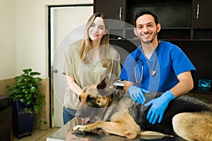 Professional vet and dog owner posing at the pet clinic