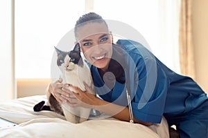 Professional Veterinarian Lady Embracing Healthy Cat At Vet Clinic