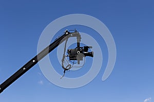 Professional Video Camera Attached To Jib Against Blue Sky