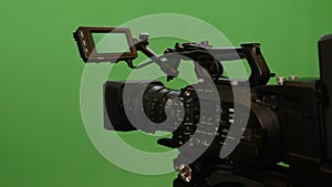 Professional video camera on green