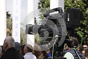 professional video camera with lens used for a live news broadcast. Professional Camera Lens. digital video camera