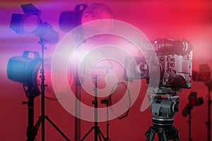 Professional video camera and lighting equipment in studio